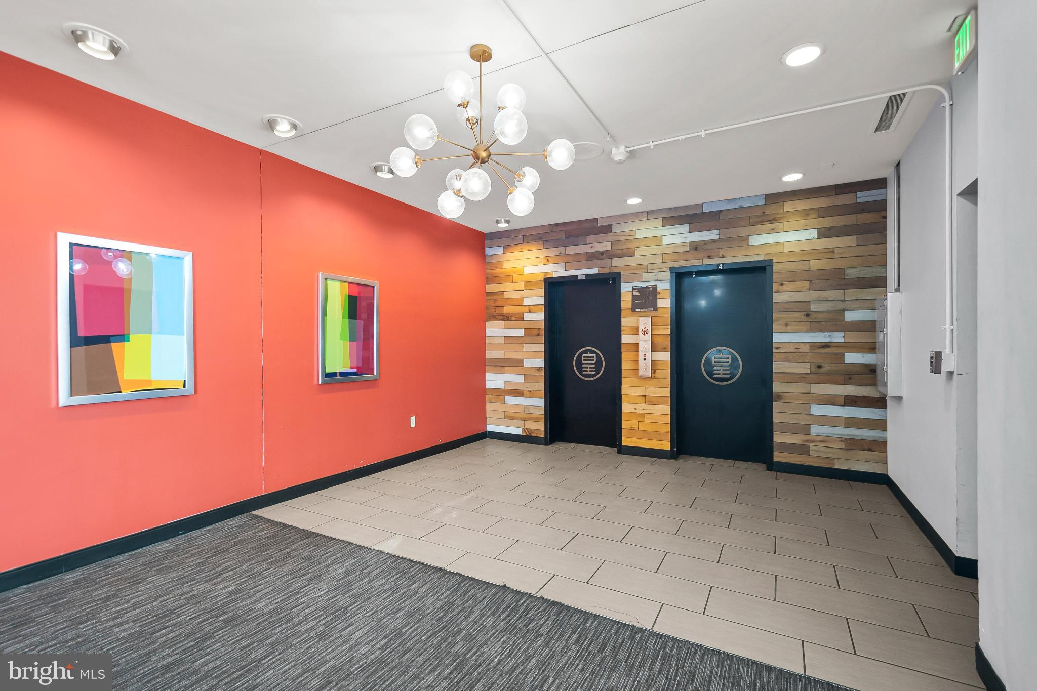 3601 Clarks Lane, Unit 322 Baltimore, MD 21215 - Photo 9 of 38 Hallway to elevators with modern art accents.