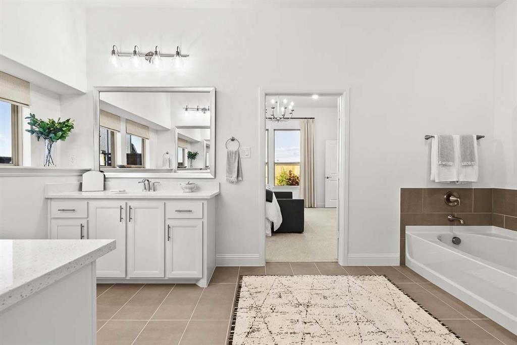 1439 Canadian Lane Van Alstyne, TX 75495 - Photo 14 of 21 a spacious bathroom with a tub sink and mirror
