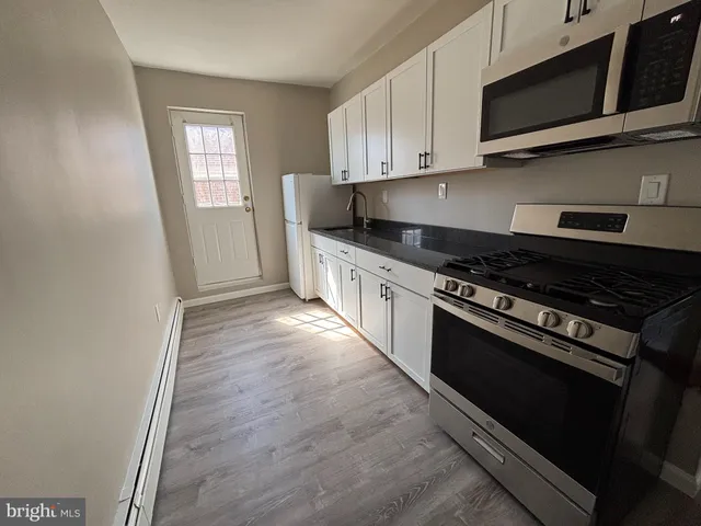 a kitchen with stainless steel appliances a stove a microwave and cabinets