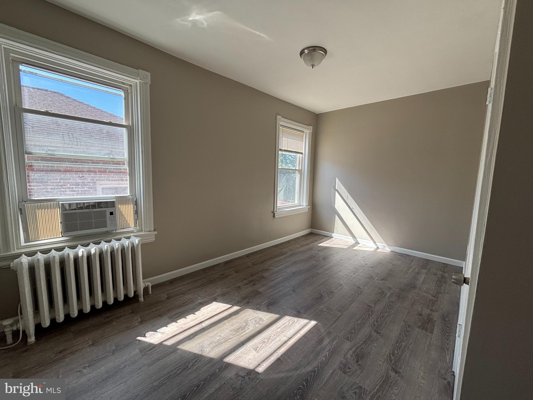 116 West 30th Street, Unit 5 Wilmington, DE 19802 - Photo 3 of 8 an empty room with windows