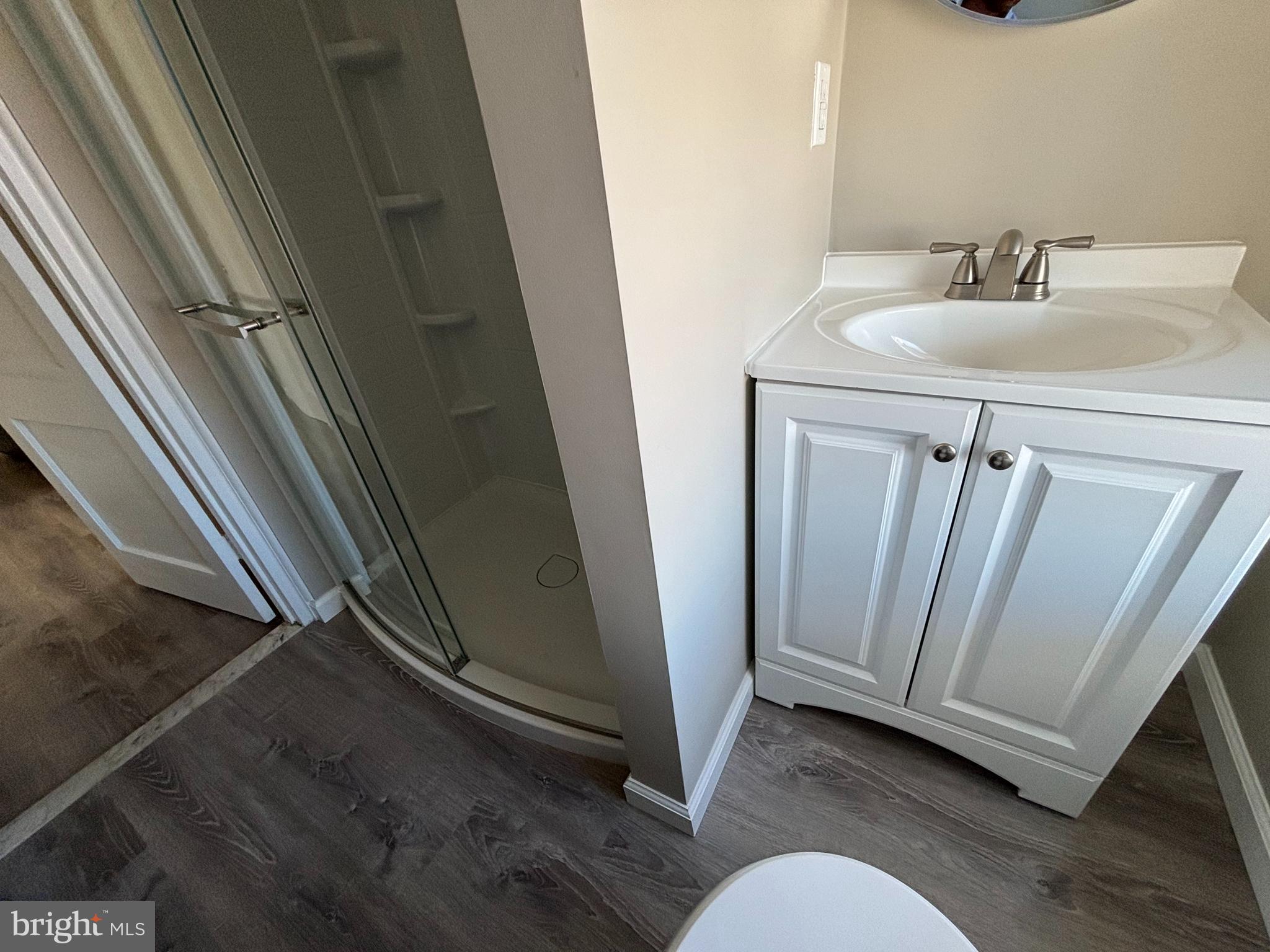 116 West 30th Street, Unit 5 Wilmington, DE 19802 - Photo 7 of 8 a bathroom with a sink a mirror and a shower