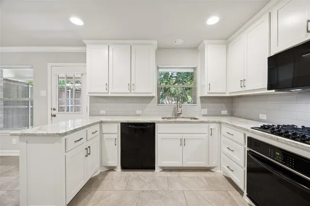 a kitchen with granite countertop white cabinets and white appliances