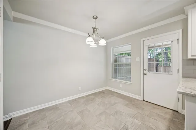 a view of a room with windows and chandelier