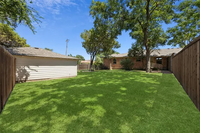 a view of house with backyard