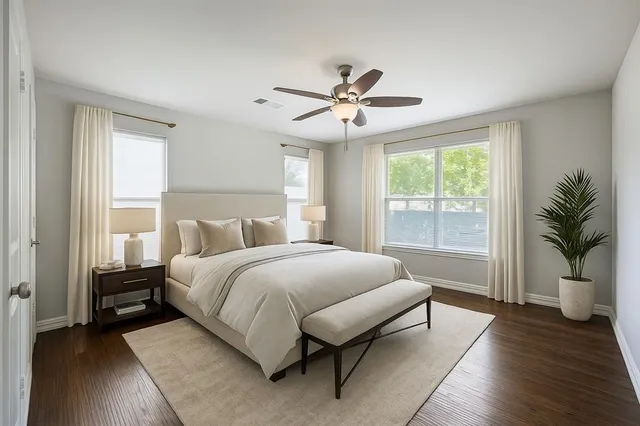 a spacious bedroom with a large bed and a chandelier