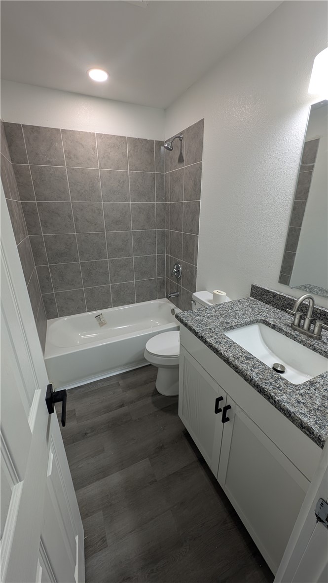 426 Carleta Street, Unit 4 Corpus Christi, TX 78418 - Photo 12 of 14 a bathroom with a granite countertop sink a toilet and shower