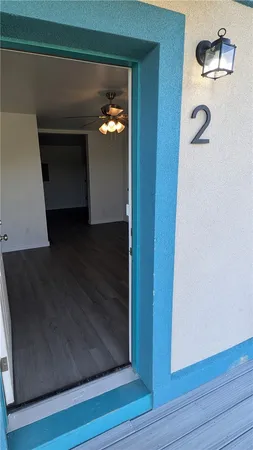 a view of a hallway with wooden floor and a fireplace