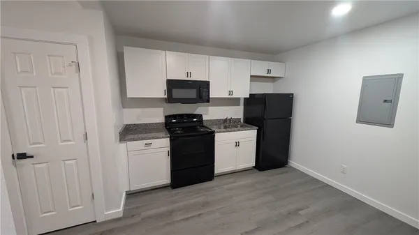 a kitchen with stainless steel appliances a refrigerator stove and microwave
