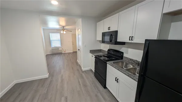 a kitchen with granite countertop a stove and a refrigerator