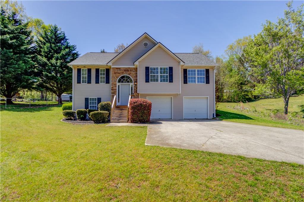7015 Ridge Way Gainesville, GA 30506 - Photo 1 of 1 a front view of a house with a yard and garage
