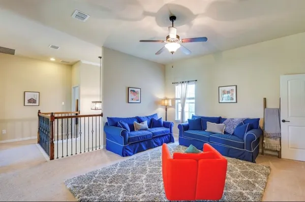 a living room with furniture and a chandelier
