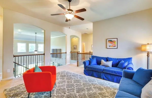 a living room with furniture ceiling fan and a rug
