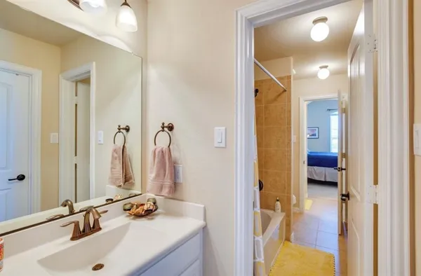 a bathroom with a sink vanity and a mirror