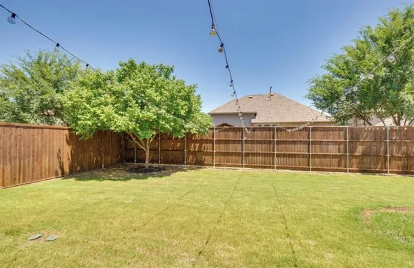 a view of a backyard with a fence