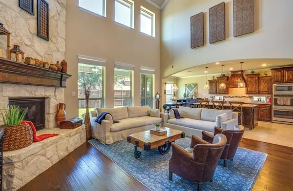 a living room with fireplace furniture and a floor to ceiling window