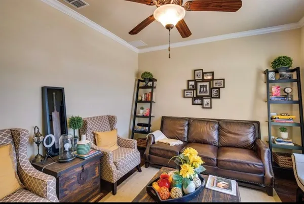 a living room with furniture and wooden floor