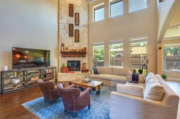 a living room with fireplace furniture and a flat screen tv