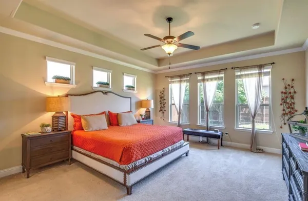 a bedroom with a bed and a chandelier