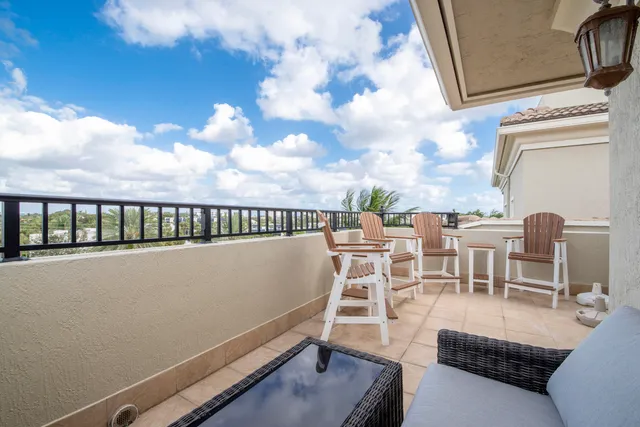 a balcony with furniture and a potted plant