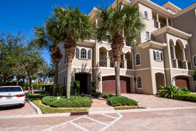 a front view of multiple houses with yard