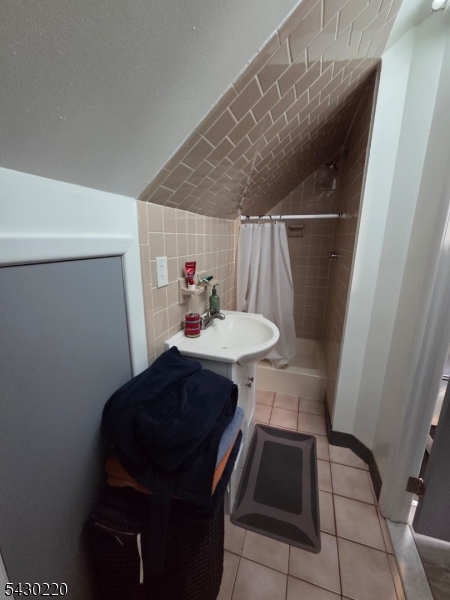 166 Carmita Avenue Rutherford, NJ 07070 - Photo 26 of 27 a bathroom with a sink and a mirror