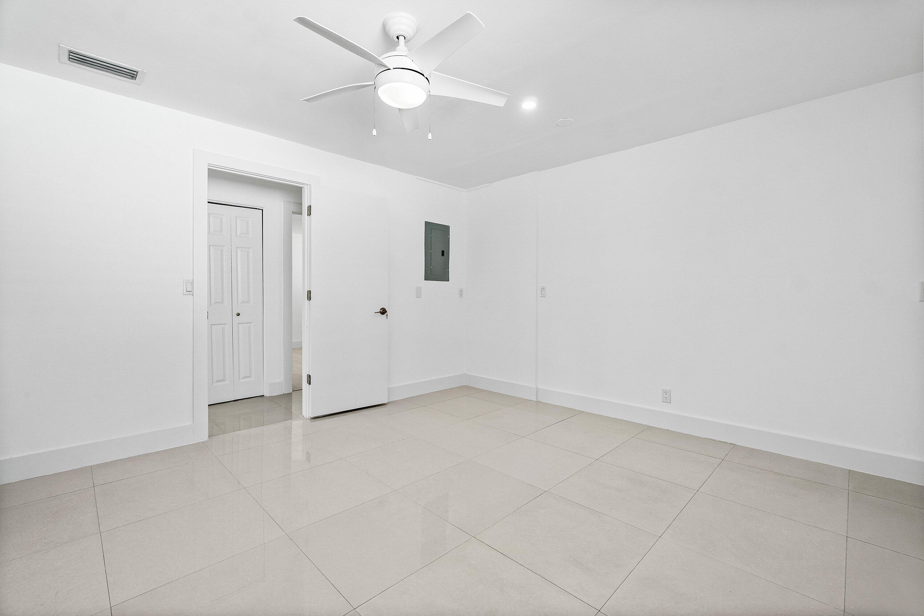 1531 Northwest 4th Street Boca Raton, FL 33486 - Photo 17 of 34 an empty room with a ceiling fan and a window
