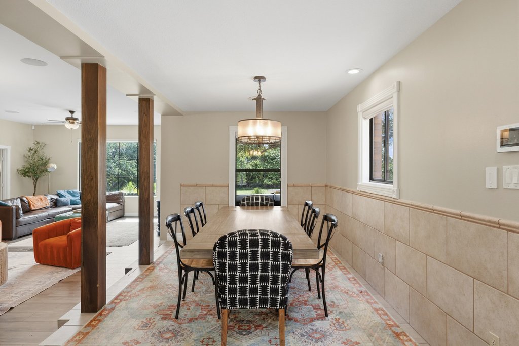12135 Fitzhugh Road Austin, TX 78736 - Photo 11 of 30 a view of a dining room with furniture wooden floor and a chandelier