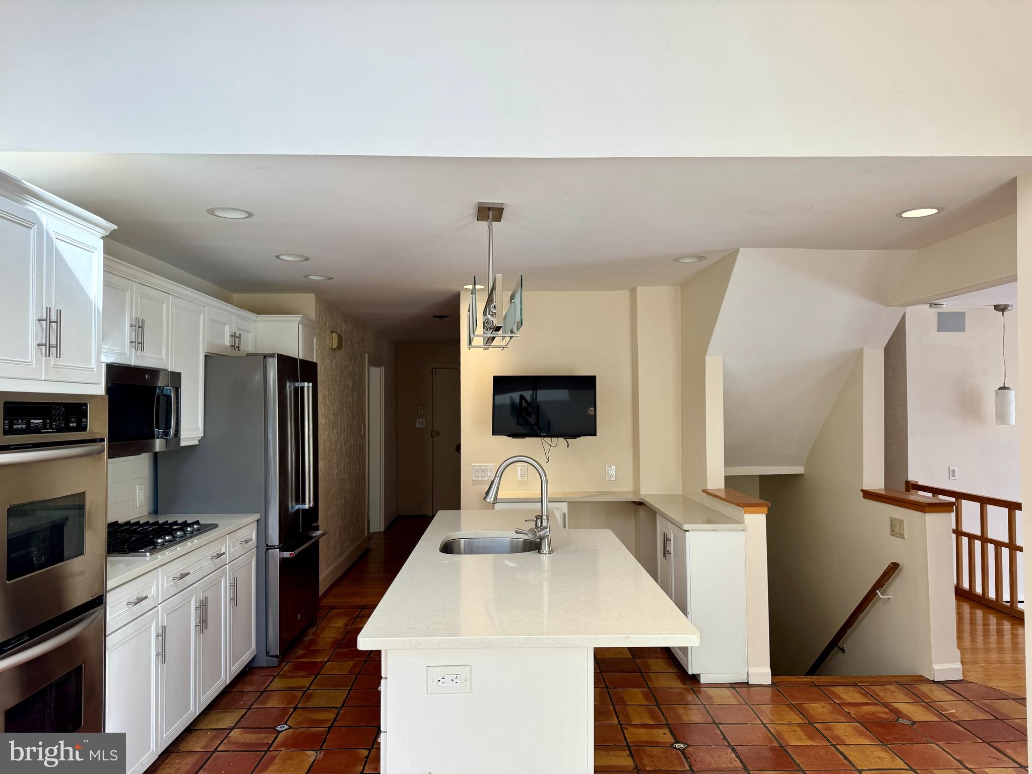 8233 Fairview Road Elkins Park, PA 19027 - Photo 3 of 36 a kitchen with stainless steel appliances a refrigerator sink and microwave