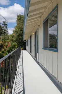 a view of balcony with wooden floor and fence