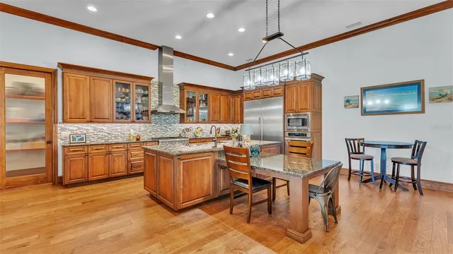 a kitchen with stainless steel appliances granite countertop a sink stove and cabinets