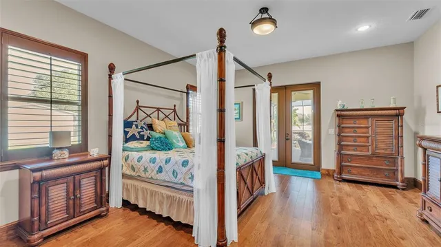 a view of a hallway with wooden floor and a dining room