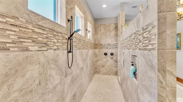 a living room with furniture a couch and next to a window