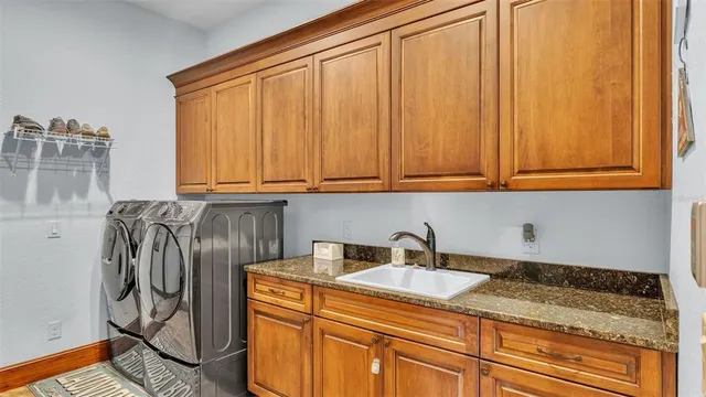 a living room with furniture a flat screen tv and a window