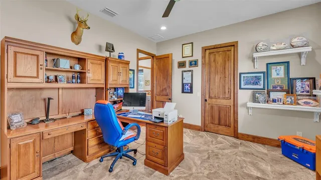 a view of a house with large windows and a small yard