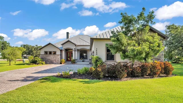 a living room with furniture fireplace and a large window