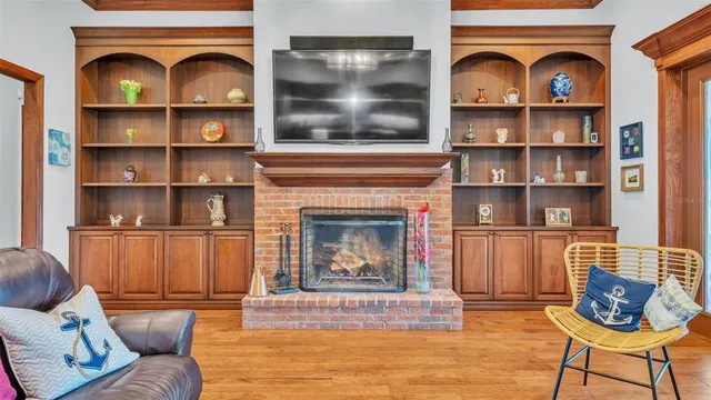 a living room with fireplace furniture and a wooden floor