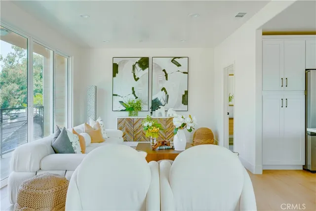 a living room with furniture and a floor to ceiling window