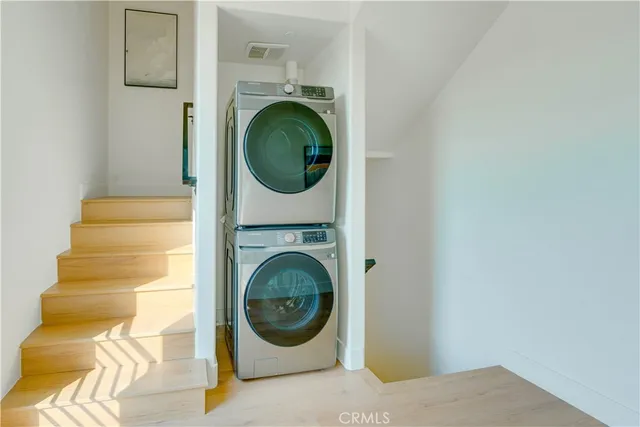 a bedroom with a bed and painting on the wall