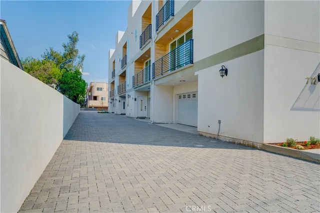 a view of a street with potted plants
