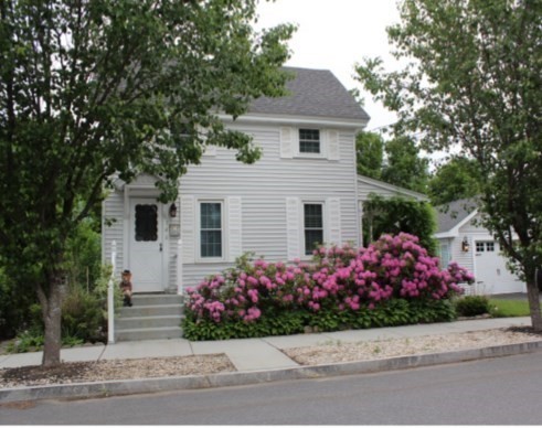 a front view of a house with yard