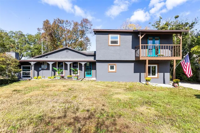 a front view of house with yard outdoor seating and barbeque oven