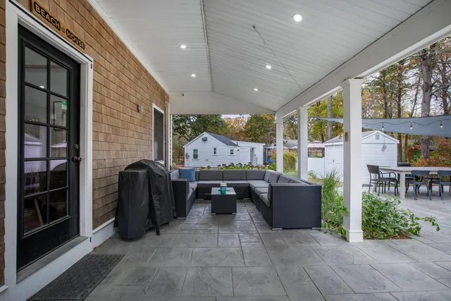 a living room with furniture and large windows