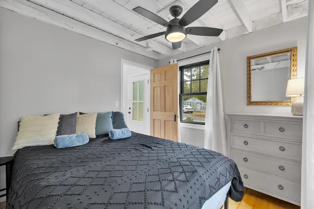 a bedroom with a large bed and a window