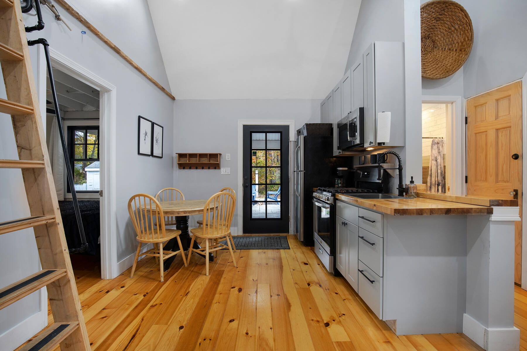262 Old Wharf Road, Unit 87 Dennis Port, MA 02639 - Photo 24 of 39 a kitchen with stainless steel appliances granite countertop a stove top oven a sink a dining table and chairs