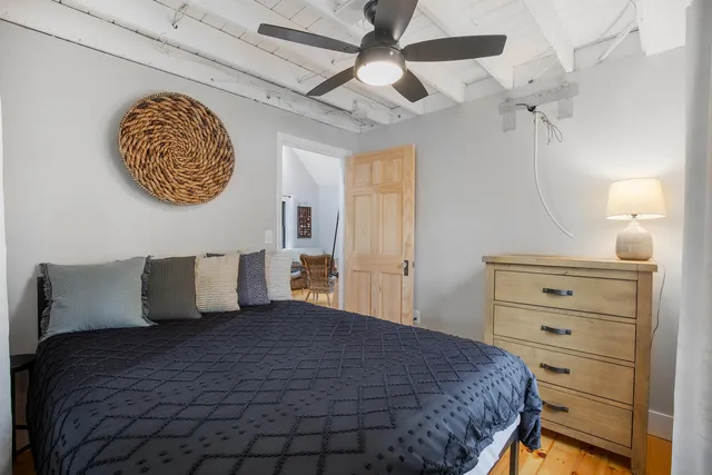 a bedroom with a large bed and a chandelier