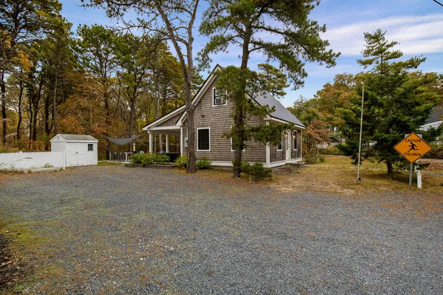 a view of a house with a yard and sitting area