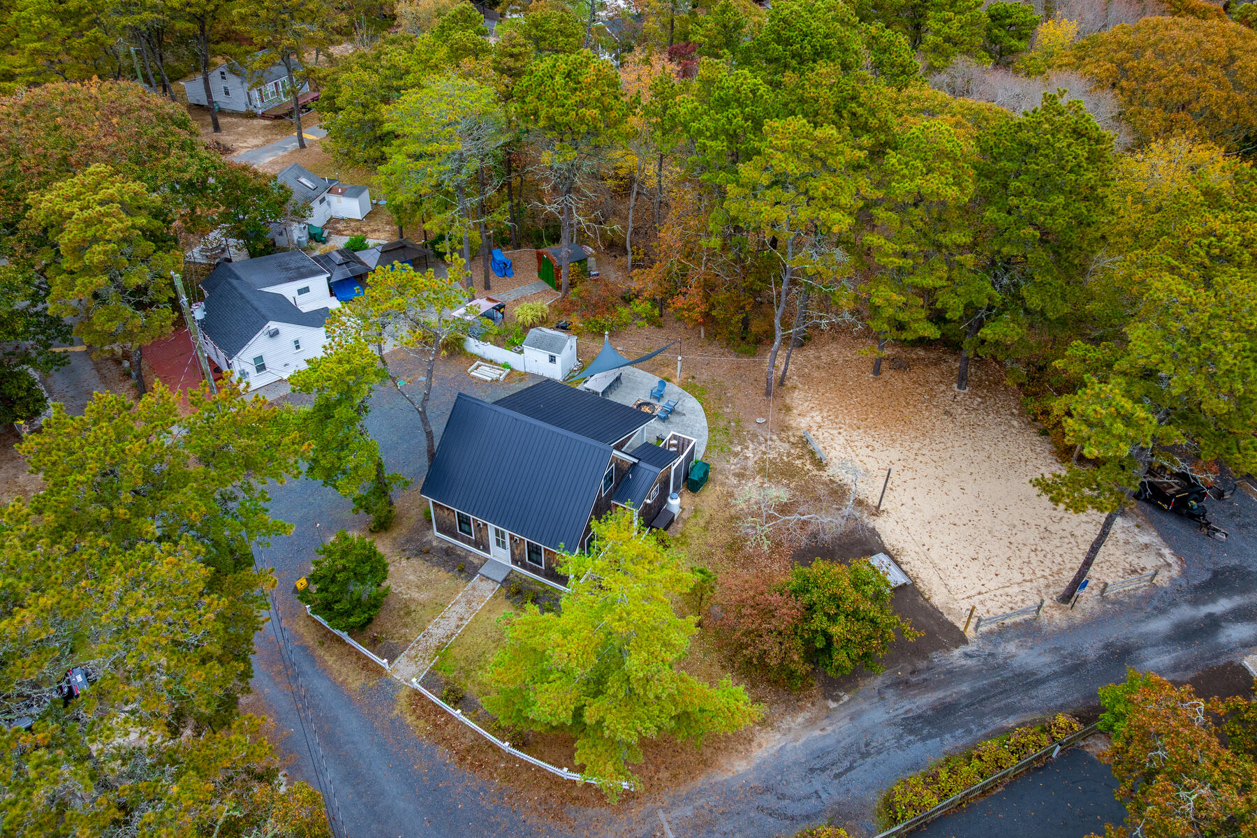 262 Old Wharf Road, Unit 87 Dennis Port, MA 02639 - Photo 34 of 39 an aerial view of a house with a yard and large trees