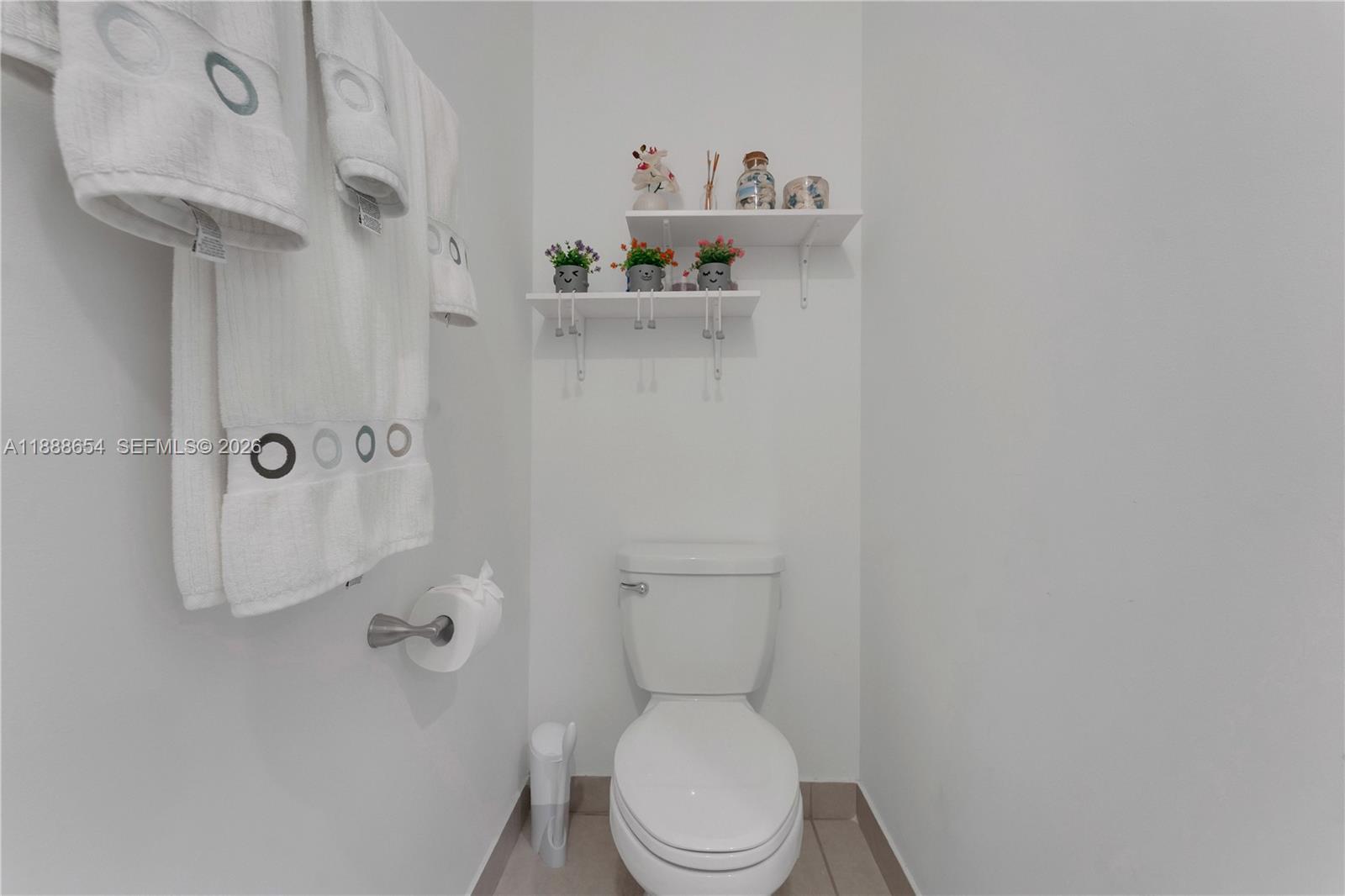 23512 Southwest 129th Path Homestead, FL 33032 - Photo 13 of 39 a white toilet sitting next to a bathroom sink