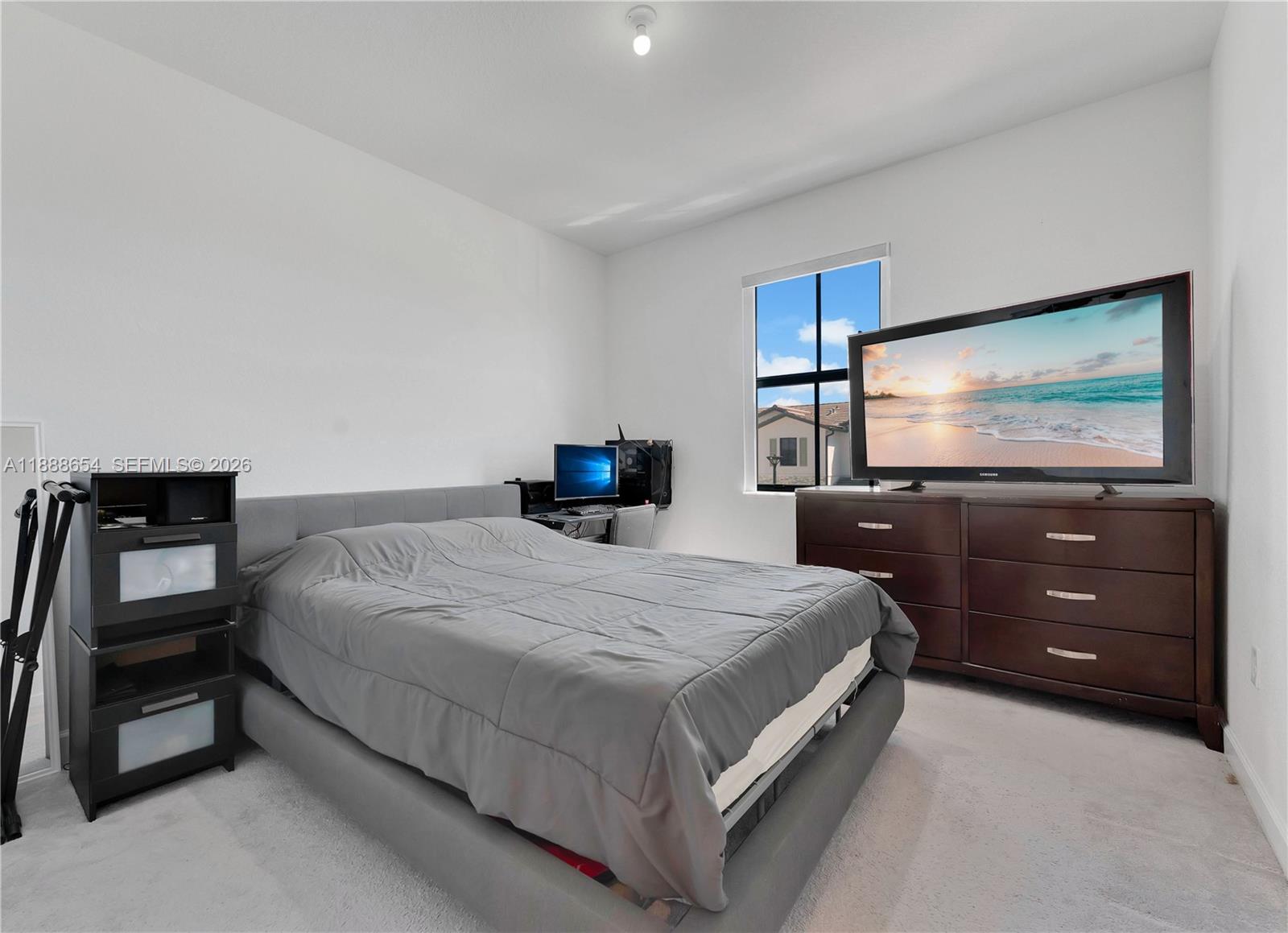 23512 Southwest 129th Path Homestead, FL 33032 - Photo 17 of 39 a bedroom with a bed and a flat screen tv