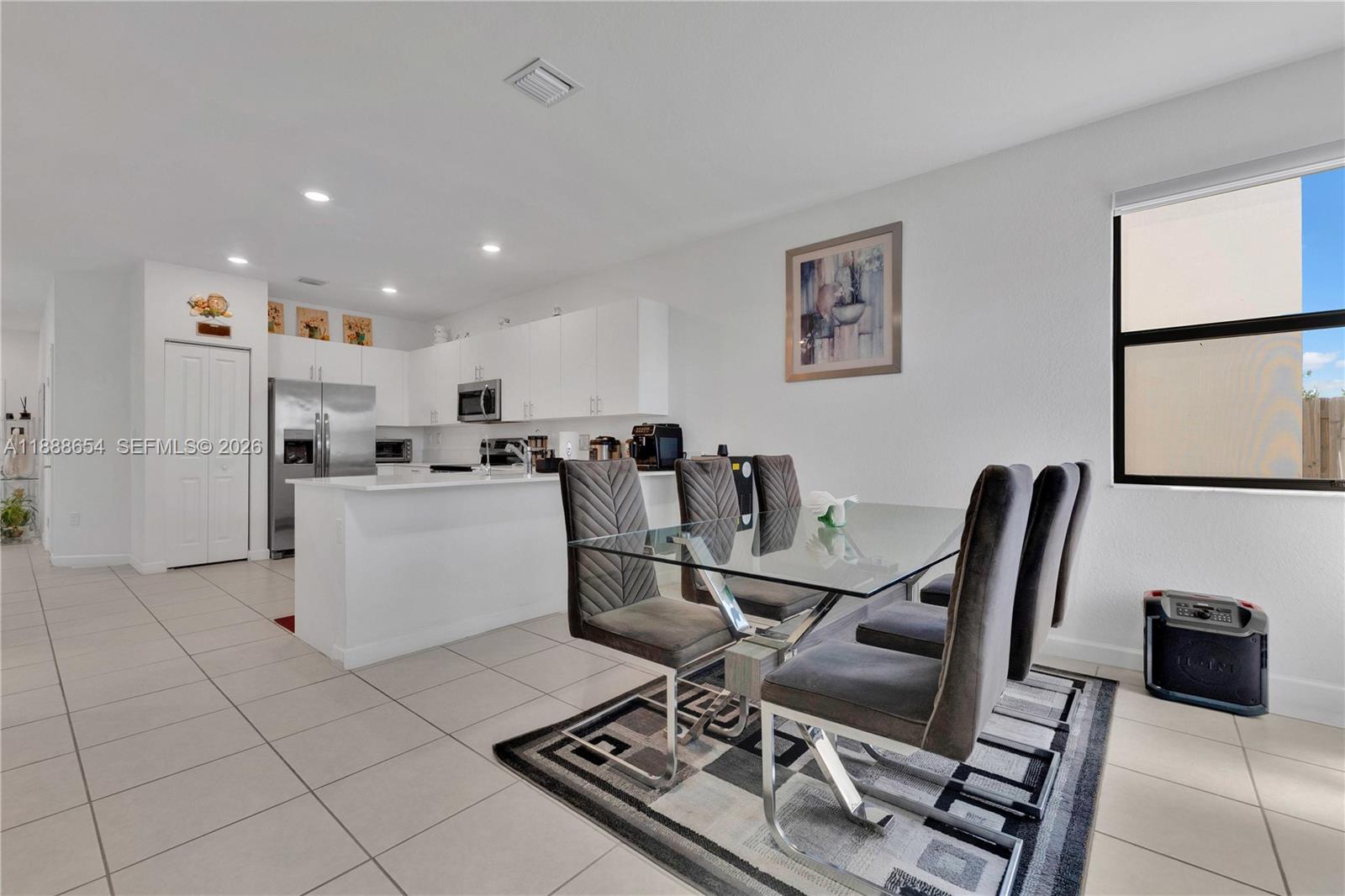 23512 Southwest 129th Path Homestead, FL 33032 - Photo 10 of 39 a dining room filled chandelier and kitchen view